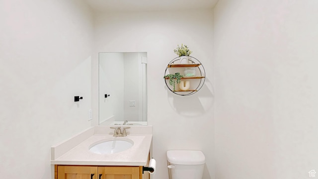 bathroom featuring toilet and vanity
