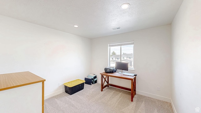 office space with light carpet, baseboards, a textured ceiling, and recessed lighting