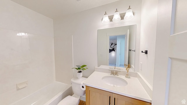 bathroom featuring toilet and vanity