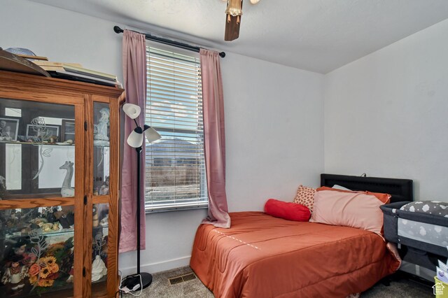 carpeted bedroom featuring multiple windows, baseboards, and a ceiling fan
