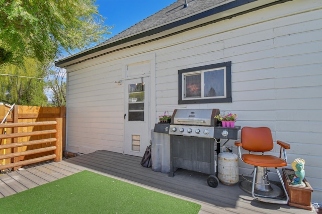 deck featuring fence and a grill