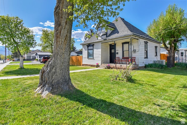 view of front of house featuring covered porch and a shingled roof