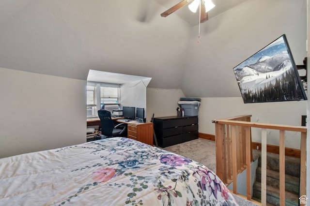 carpeted bedroom with vaulted ceiling, an office area, a ceiling fan, and baseboards