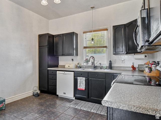 489 E Center St, Heber City, UT 84032 - kitchen with white dishwasher, stainless steel microwave, decorative light fixtures, light countertops, and freestanding refrigerator