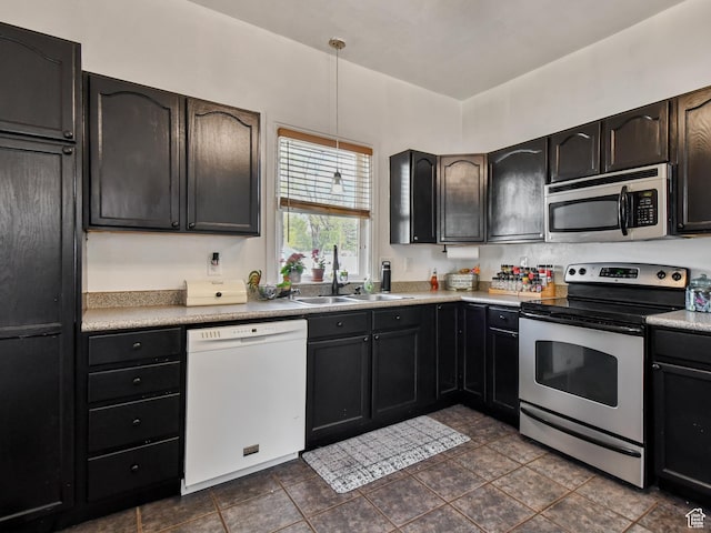 489 E Center St, Heber City, UT 84032 - kitchen featuring appliances with stainless steel finishes, pendant lighting, light countertops, and dark tile patterned flooring