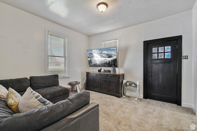 carpeted living area with baseboards