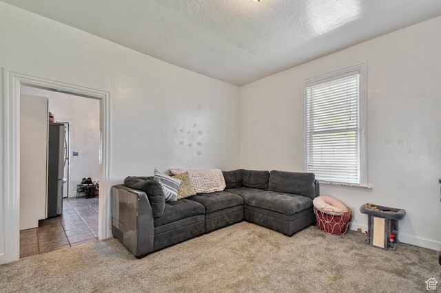 carpeted living room with baseboards