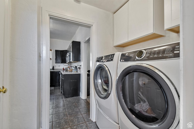 washroom featuring washer and clothes dryer and cabinet space