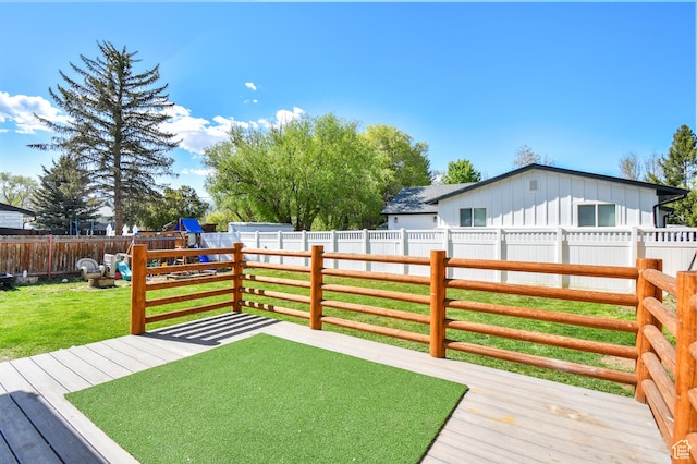 wooden deck featuring a playground