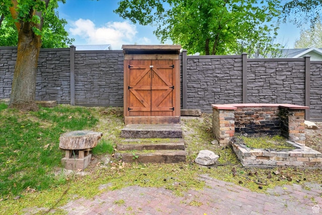 view of outdoor structure featuring a gate and fence