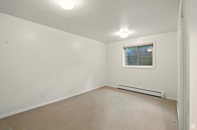 unfurnished room with baseboard heating, light carpet, and baseboards