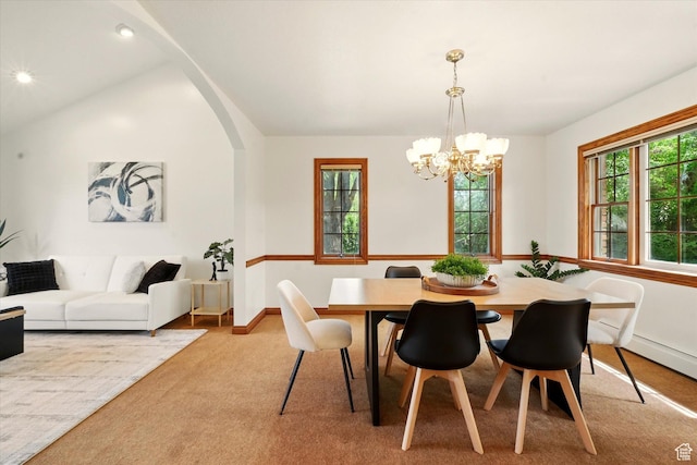 dining area with a chandelier, vaulted ceiling, light colored carpet, baseboards, and recessed lighting