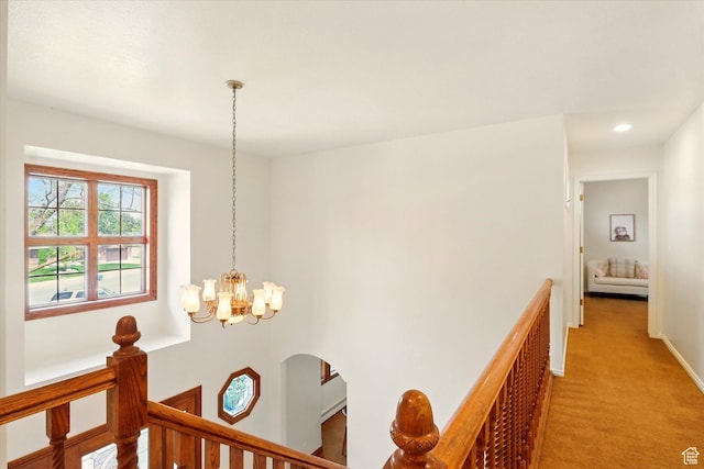 hall featuring an upstairs landing, a chandelier, light carpet, recessed lighting, and baseboards