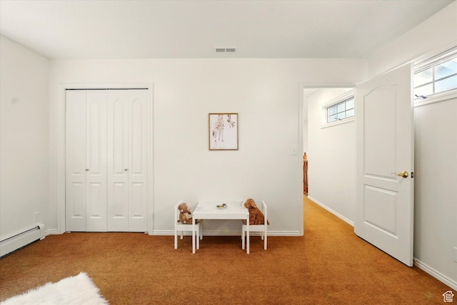 bedroom featuring carpet, a baseboard heating unit, a closet, and baseboards