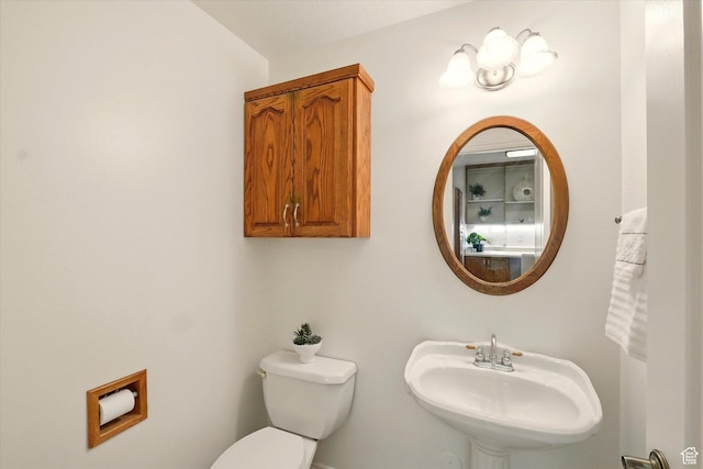 half bath with a sink and toilet