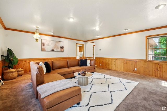 living area with a wainscoted wall, wood walls, carpet floors, and ornamental molding