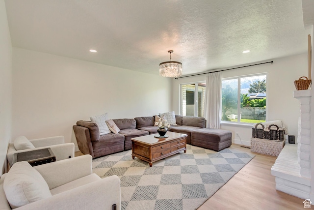 1145 S 350 W, Orem, UT 84058 - living area with light wood finished floors, recessed lighting, a chandelier, baseboards, and a textured ceiling