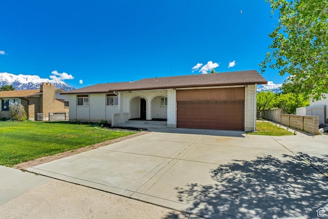 1145 S 350 W, Orem, UT 84058 - ranch-style home with brick siding, an attached garage, and driveway