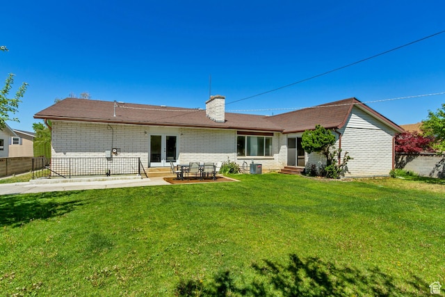 1145 S 350 W, Orem, UT 84058 - rear view of house with entry steps, a chimney, french doors, central AC unit, and brick siding