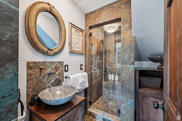 full bath featuring a stall shower and vanity
