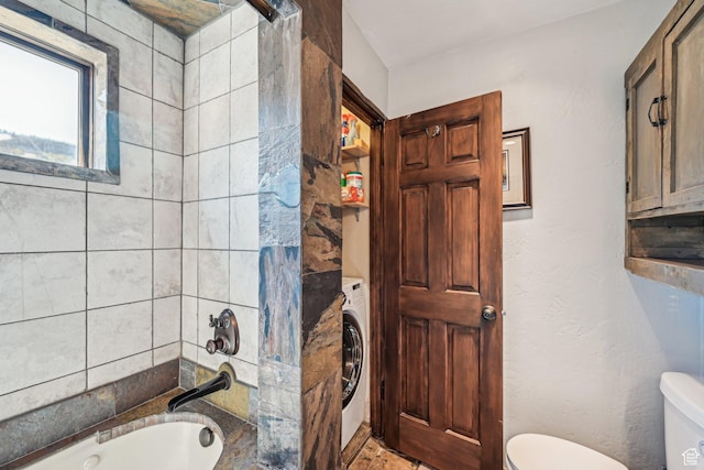 full bath featuring toilet, washer / clothes dryer, and  shower combination
