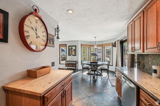 kitchen featuring butcher block countertops, stone tile flooring, dishwasher, tasteful backsplash, and brown cabinetry