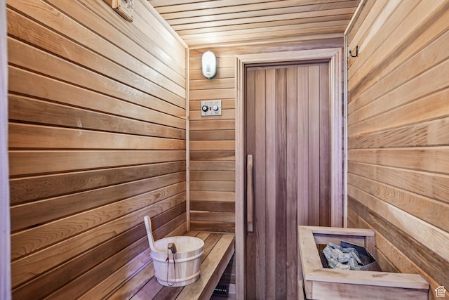 sauna with wood walls and wood ceiling