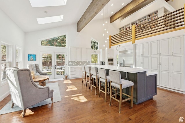 3339 W Big Spruce Way, Park City, UT 84098 - kitchen with built in appliances, high vaulted ceiling, white cabinetry, beam ceiling, and decorative backsplash