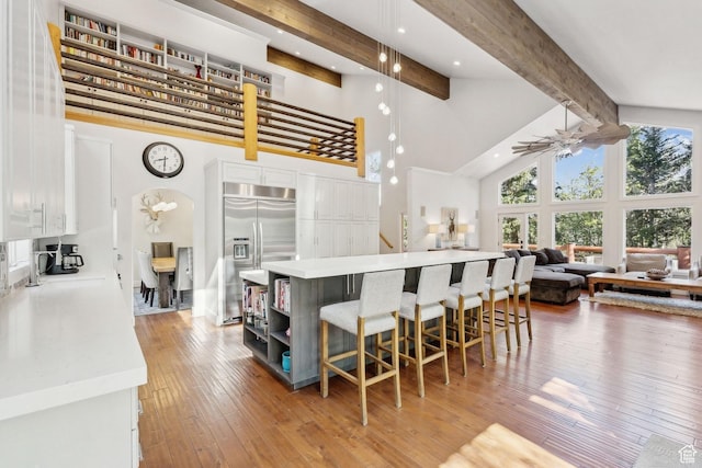 3339 W Big Spruce Way, Park City, UT 84098 - kitchen featuring stainless steel built in refrigerator, high vaulted ceiling, beamed ceiling, white cabinets, and open floor plan