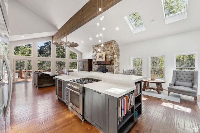 3339 W Big Spruce Way, Park City, UT 84098 - kitchen featuring open floor plan, high vaulted ceiling, appliances with stainless steel finishes, a fireplace, and beam ceiling