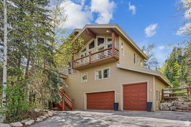 3339 W Big Spruce Way, Park City, UT 84098 - rear view of property featuring a garage, a balcony, driveway, and stairs