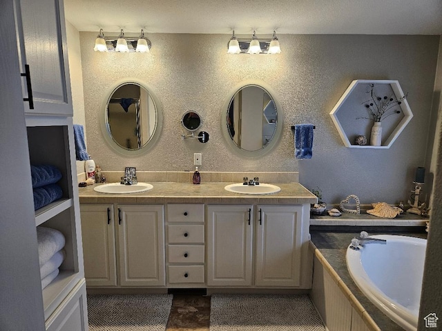 550 S Stump Hollow Rd, Garden City, UT 84028 - full bathroom with double vanity, a bathtub, and a textured wall