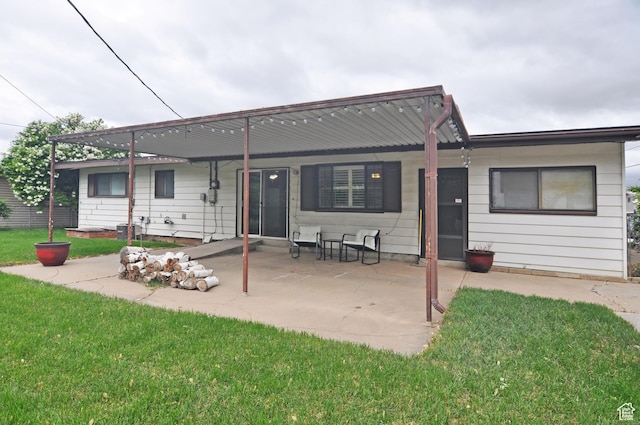 back of property featuring a yard and a patio area