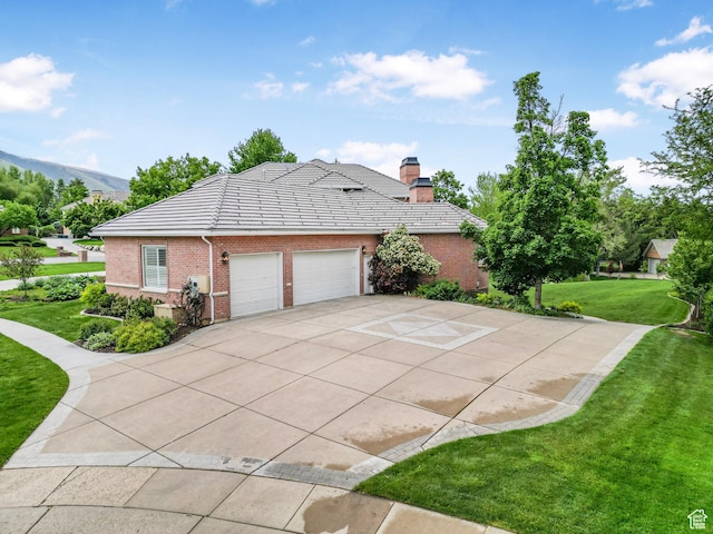 1971 Summerwood Dr, Farmington, UT 84025 - view of home's exterior with a lawn, an attached garage, concrete driveway, brick siding, and a chimney