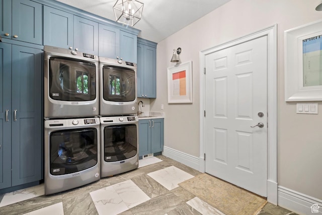 1971 Summerwood Dr, Farmington, UT 84025 - laundry area featuring cabinet space, stacked washer / drying machine, baseboards, light marble finish flooring, and a chandelier