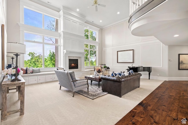 1971 Summerwood Dr, Farmington, UT 84025 - living area with a high ceiling, crown molding, a decorative wall, a lit fireplace, and light wood finished floors
