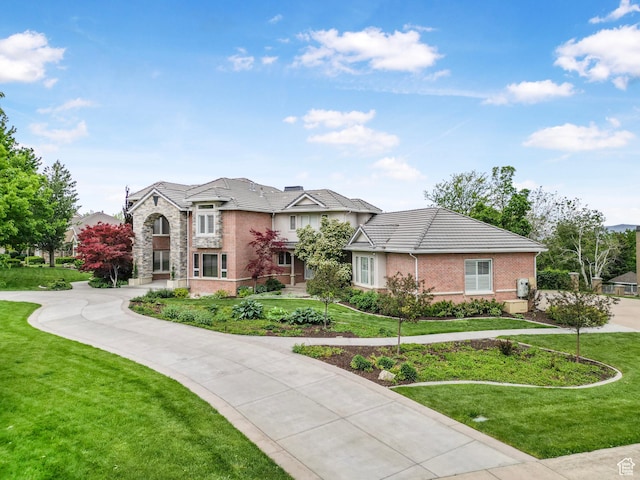 1971 Summerwood Dr, Farmington, UT 84025 - view of front of house featuring a front lawn, stone siding, and curved driveway