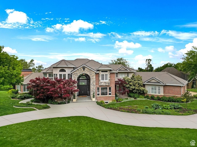 1971 Summerwood Dr, Farmington, UT 84025 - view of front facade with a front lawn, stone siding, and stucco siding