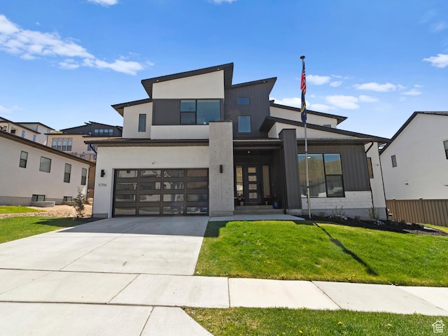 modern home featuring concrete driveway, an attached garage, and stucco siding