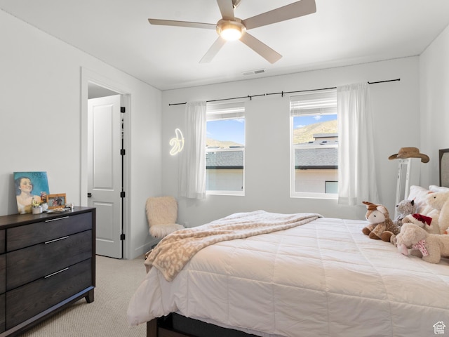 bedroom featuring light carpet and ceiling fan
