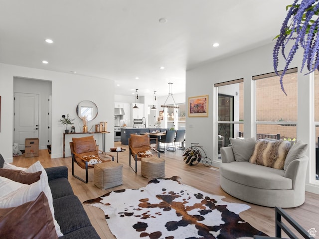 living room with light wood-style floors and recessed lighting