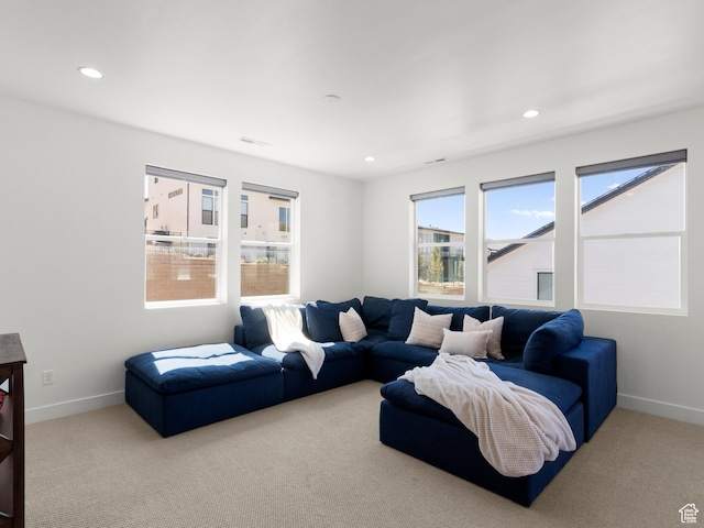 carpeted living area featuring recessed lighting and baseboards
