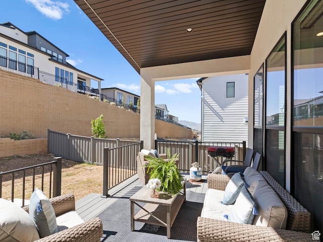 view of patio with an outdoor living space, fence, and a residential view
