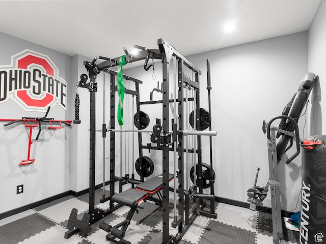 exercise room featuring baseboards and carpet floors