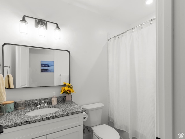 bathroom with vanity, toilet, and a shower with shower curtain