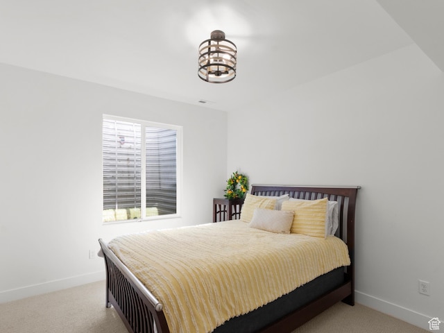 bedroom featuring carpet floors, baseboards, and a chandelier