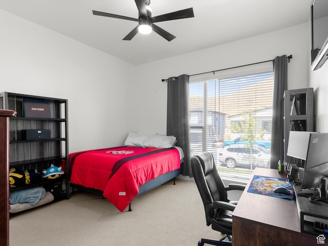 bedroom with carpet flooring, a desk, and a ceiling fan