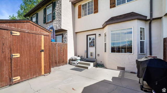 back of house featuring stucco siding, fence, and a patio area