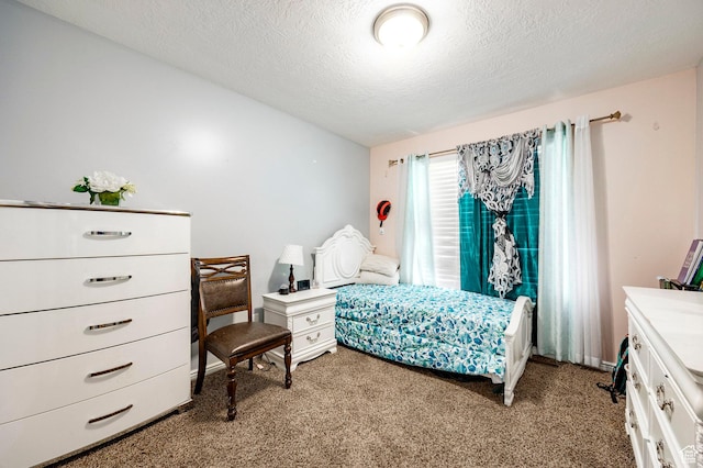 carpeted bedroom with a textured ceiling