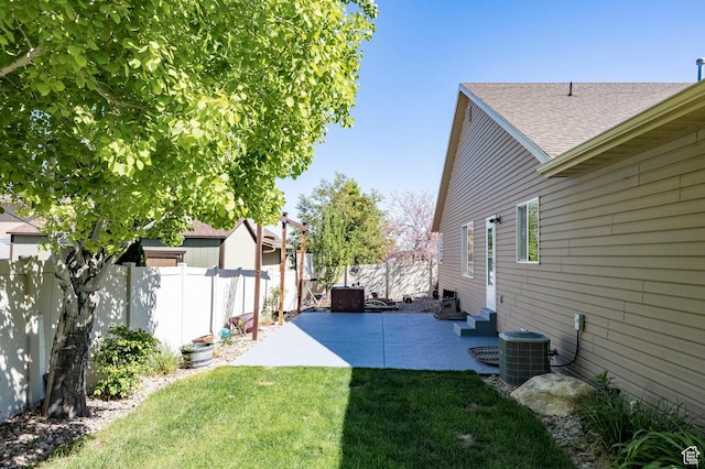 view of yard featuring central AC and a patio area